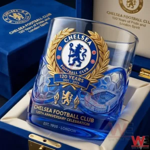 A Chelsea football club anniversary glass resting in a blue presentation box with detailed crest artwork and celebration theme!
