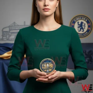 A Chelsea themed commemorative coin is displayed in both hands with the background softly blurred to highlight the product!
