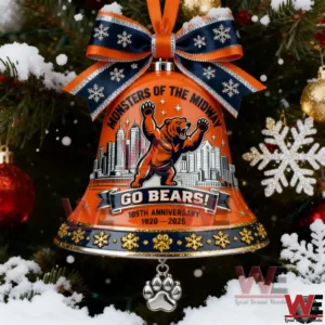 Orange Chicago Bears bell ornament with navy and orange bow and paw charm hanging on a snowy Christmas tree!