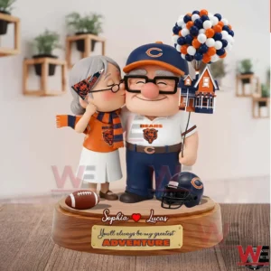 This image presents a customized Chicago Bears couple statue with expressive faces team colors and a heartfelt design celebrating love and shared fandom!