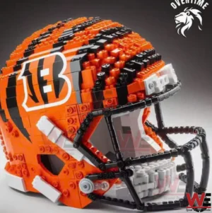 A close up of an orange and black football helmet made from building blocks showing detailed texture stripes and a realistic face guard design!