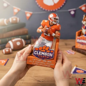 Clemson Tigers 130th Anniversary Bookends 3 A person holding a Clemson Tigers bookend with a football quarterback figure and Clemson Tigers logo in a decorated sports themed room!