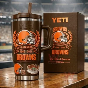 Brown YETI Browns 80th Anniversary tumbler next to a Browns themed gift box on a table with a blurred stadium behind!