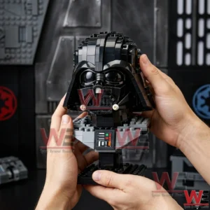 Hands holding a brick built Darth Vader helmet display model on a stand against a dark sci fi themed background with imperial style symbols!
