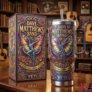 A Yeti tumbler and presentation box featuring Dave Matthews Band butterfly artwork placed in a warm setting with guitars books and music decor!