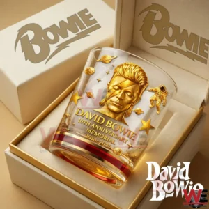A boxed whiskey glass features a gold David Bowie tribute with space themed decorations presented in an elegant gift package!