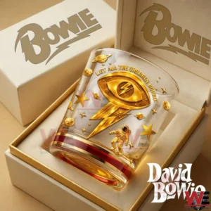 A whiskey glass in a gift box shows a gold lightning symbol astronaut and stars representing a David Bowie inspired memorial design!