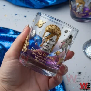 David Bowie 10th Anniversary Memorial 2016-2026 Whiskey Glass 5 Hand holding a David Bowie memorial whiskey glass featuring galaxy artwork and anniversary design!