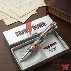 Luxury David Bowie Starman themed pen resting inside an open gift box with branded packaging on a wooden desk!