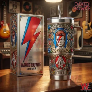 David Bowie Starman insulated tumbler with handle and straw displayed next to a matching box on a wooden table with music memorabilia!