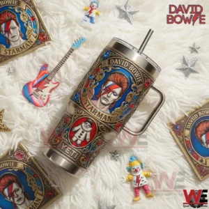 David Bowie Starman insulated tumbler with handle and straw placed on a decorative surface with music themed accessories!