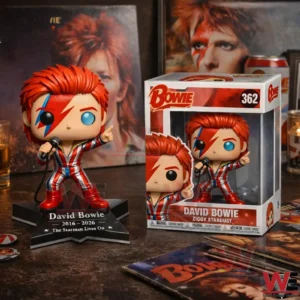 David Bowie Ziggy Stardust vinyl figure on a base beside a Bowie box with records and portrait posters behind!