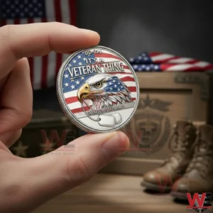 Hand holding a veteran commemorative coin with eagle artwork and patriotic background in a military themed setting!