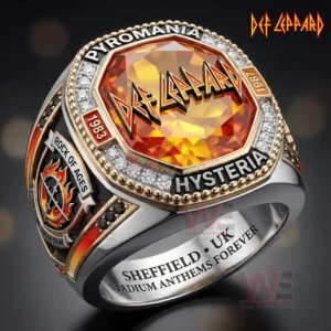 Close up of a Def Leppard themed ring with orange gemstone face Def Leppard logo Pyromania and Hysteria text year plaques Rock Of Ages side emblem diamond style border and Sheffield UK Stadium Anthems Forever engraving inside the band