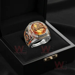 Def Leppard themed ring with orange gemstone face and sparkling border sitting inside an open black jewelry box with Sheffield UK Stadium Anthems Forever engraving visible