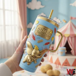 Hand holding a light blue Dumbo themed metal tumbler with gold details in a bright playful room!