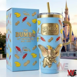 Dumbo themed metal tumbler with gold handle and straw displayed next to a matching box with a castle behind!