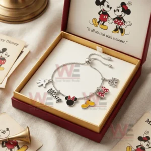 Open gift box holding a silver adjustable charm bracelet with Mickey and Minnie themed charms and a lid showing Mickey and Minnie with the text It all started with a mouse.