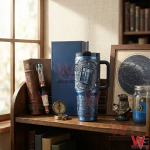 Blue science fiction tumbler with handle displayed on a wooden shelf in a study with books and themed decor!