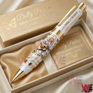Dolly Parton eightieth anniversary ballpoint pen in a gift box featuring white and gold design butterfly details and an illustration of a woman playing guitar.