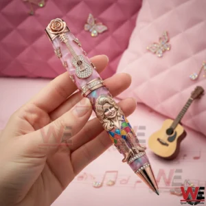 Dolly Parton Backwoods Barbie Pen 3 Hand holding a Dolly Parton themed collectible pen with sculpted portrait butterfly details and musical background!