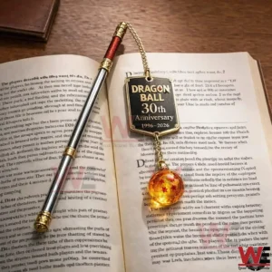 Dragon Ball 30th Anniversary 1996-2026 Bookmark 3 The image shows a decorative bookmark placed on an open book with clear focus on the anniversary design and hanging orb detail!