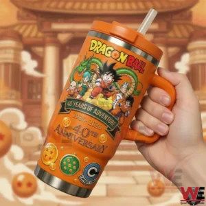 Dragon Ball 40 Years of Adventure 1986-2026 Tumbler 5 Hand holding Dragon Ball forty year anniversary tumbler with character artwork and bold orange finish!