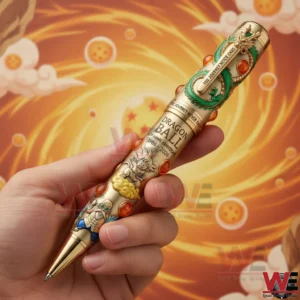 Hand holding a Dragon Ball themed gold commemorative pen with decorative dragon design and glowing background.