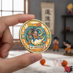 Dragon Ball 40th Anniversary Commemorative Coin 4 Hand holding a Dragon Ball fortieth anniversary commemorative coin with colorful hero and dragon artwork against a softly focused room background!