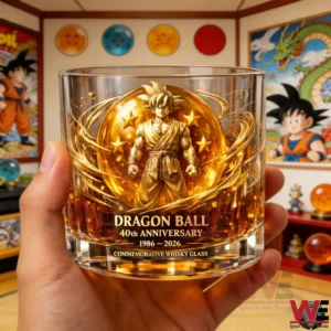 Close view of a hand holding a Dragon Ball fortieth anniversary commemorative whisky glass with a golden warrior illustration and glowing energy design displayed in a themed collector room!