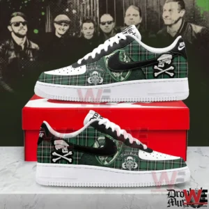 Green plaid low top sneakers with white toe boxes black side logo and skull and crossbones artwork displayed on a red shoe box.