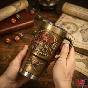 Hands holding a bronze Dungeons And Dragons 52nd anniversary tumbler with handle and straw showing a dragon crest and twenty sided dice emblem with maps books and dice in the background