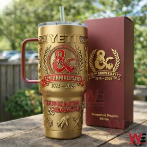 Gold and red Dungeons and Dragons anniversary tumbler with dragon crest beside a matching burgundy gift box on an outdoor table!