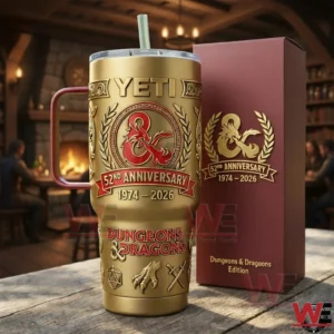 Gold and red Dungeons and Dragons anniversary tumbler with dragon crest beside a matching burgundy gift box in a warm indoor tavern setting!