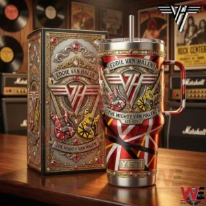 A red and gold rock music themed insulated tumbler with an Eddie Van Halen inspired crest and guitars standing next to a decorative box in a studio filled with amplifiers and vinyl records!