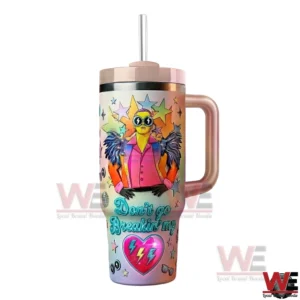 Elton John themed tumbler with colorful illustrated character star patterns heart design handle lid and straw displayed on a white background!