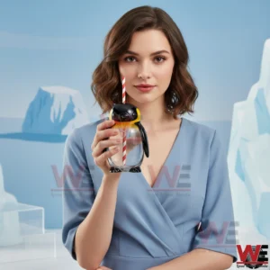 Woman holding penguin shaped glass cup with straw! ``