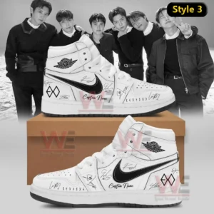 Two white high top sneakers with black swoosh EXO logos signature graphics and custom name detail displayed on a shoebox with a black and white group photo backdrop!