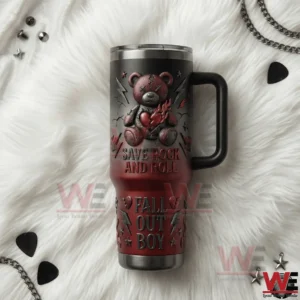 A flat lay view of a Yeti tumbler showcasing Fall Out Boy Save Rock And Roll artwork placed on a white fur background with rock themed details!