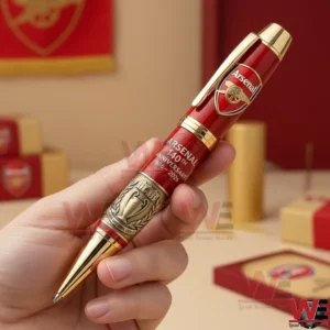 Arsenal 140th Anniversary 1886-2026 Ballpoint Pen 5 Arsenal anniversary ballpoint pen held by hand showing red body gold trim and engraved club details!