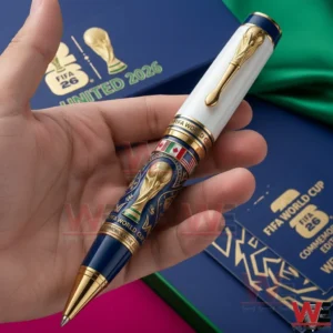 Hand holding a blue white and gold football commemorative pen with presentation boxes behind!