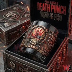 A themed whiskey glass placed inside an open metal box featuring skull art chains and a strong industrial design!