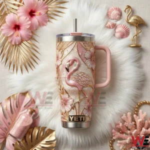 Flamingo insulated tumbler with pink handle floral patterns gold accents and tropical decorative elements arranged around the product!