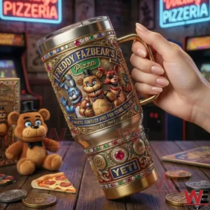 Hand holding a Freddy Fazbears Pizza Yeti tumbler in front of arcade machines!