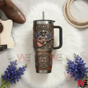 Handled tumbler with embossed cowboy playing guitar on white fur surrounded by a boot rope small guitar and blue flowers!