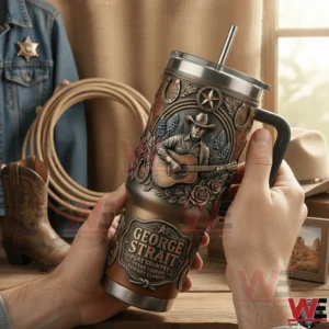 Hands holding a western themed handled tumbler with embossed cowboy playing guitar with boots rope and rustic western decor in the background!