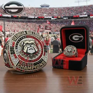 Large Georgia Bulldogs 2025 SEC Champions ring with a bulldog emblem and red black and silver stones displayed next to a branded presentation box in a stadium setting!