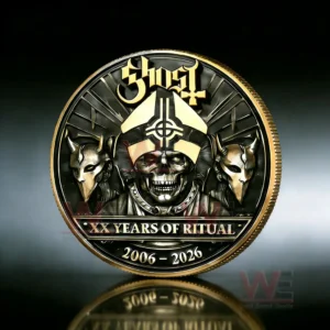 Close up of a Ghost commemorative coin with skull imagery gold accents and the text twenty years of ritual two thousand six to two thousand twenty six.