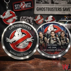 Two Ghostbusters collectible coins featuring the classic logo and a character design with the phrase We Came We Saw We Kicked Its Ass on a wooden table!