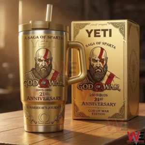 A God Of War insulated tumbler and anniversary box displayed on a wooden table with warm ambient lighting!